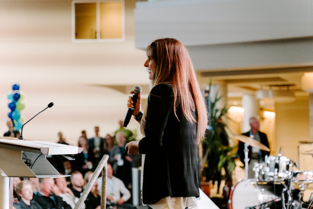 Hyon's Kristy Ehman pitching her company in front of a crowd