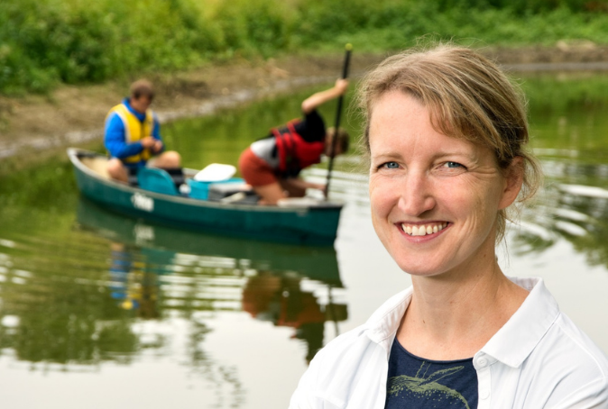 Dr. Kerri Finlay, associate professor in biology, with her students testing water in a farmer's dugout in Saskatchewan. Photo by Trevor Hopkin.