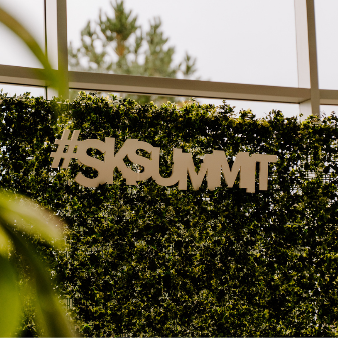 Sask Summit hashtag displayed on green leaf backdrop