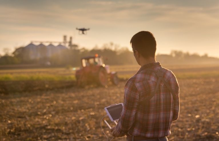 Ag producer in field with drone