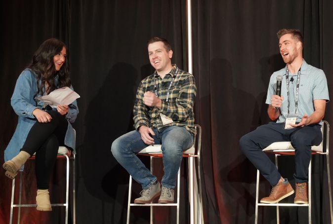 Three people sit on high stools as they discuss agtech topics during a panel at Grain Expo 2022.